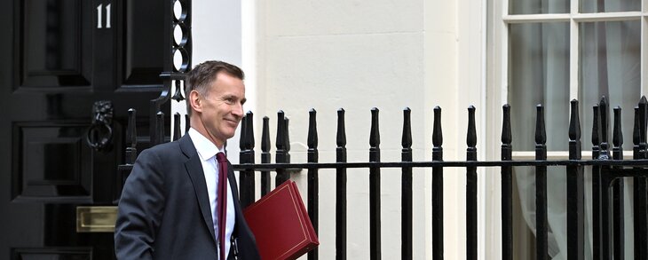 Chancellor Jeremy Hunt is pictured holding his ministerial file walking away from 11 Downing Street to wards Number 10.